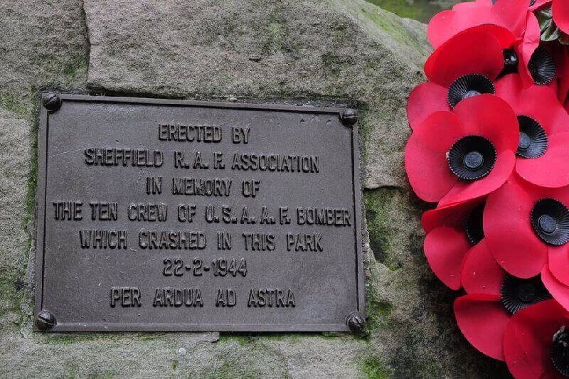 Bronze memorial with wreath of red poppies