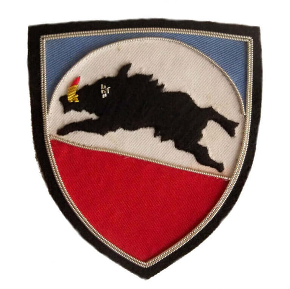 Shield shaped patch with black boar facing left on white red and blue background