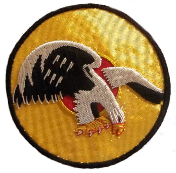 Gold circle shaped patch with flying eagle in center and black embroidered edge of patch