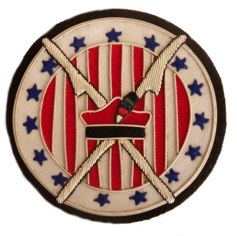White circle shaped patch with 13 blue stars around outer edge, and red and white stripes on inner circle.  With silver scythes crossed and Polish Kraskuska hat in red and black  in center