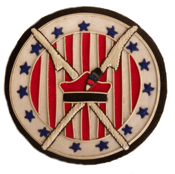 White circle shaped patch with 13 blue stars around outer edge, and red and white stripes on inner circle.  With silver scythes crossed and Polish Kraskuska hat in red and black  in center