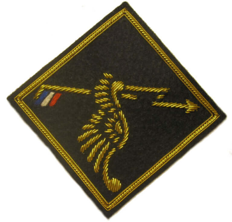 Black diamond shaped patch with gold embroidered flash across center and Polish coat of arms wing
