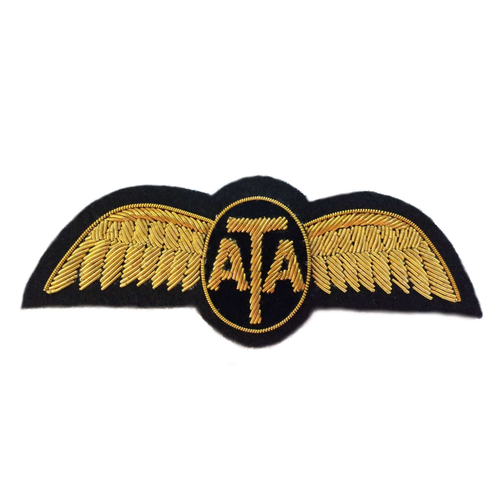 Gold wings shaped patch on black background.  Letters 'ATA' in center