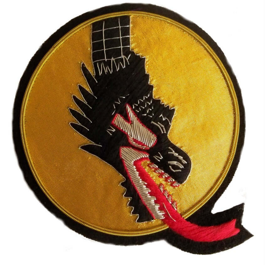Gold oval shaped patch with black dragon head and neck coming from top of patch.  Dragon mouth is open and spitting red fire