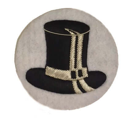White circle shaped patch with black top hat in center