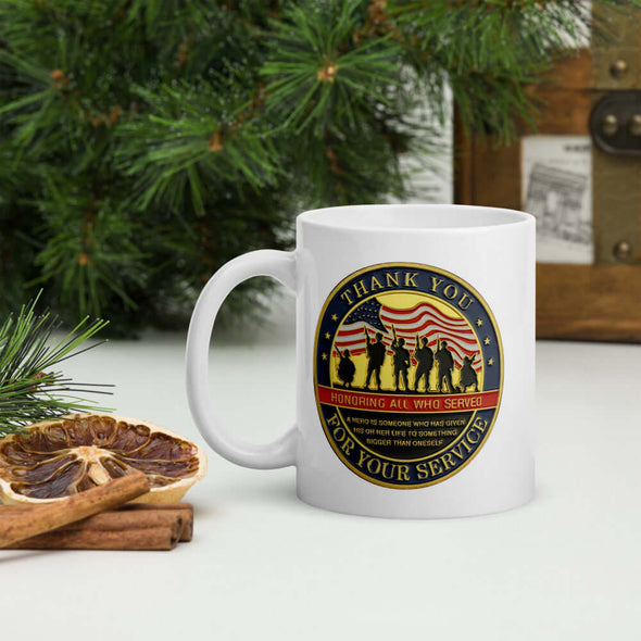 Thank You For Your Service white ceramic mug with full color patriotic graphic on both sides, with pine tree, cinnamon sticks and dried oranges setting